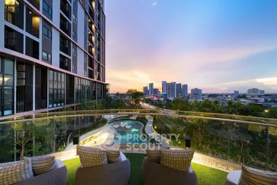 Luxurious balcony view with pool and city skyline at sunset, perfect for urban living.