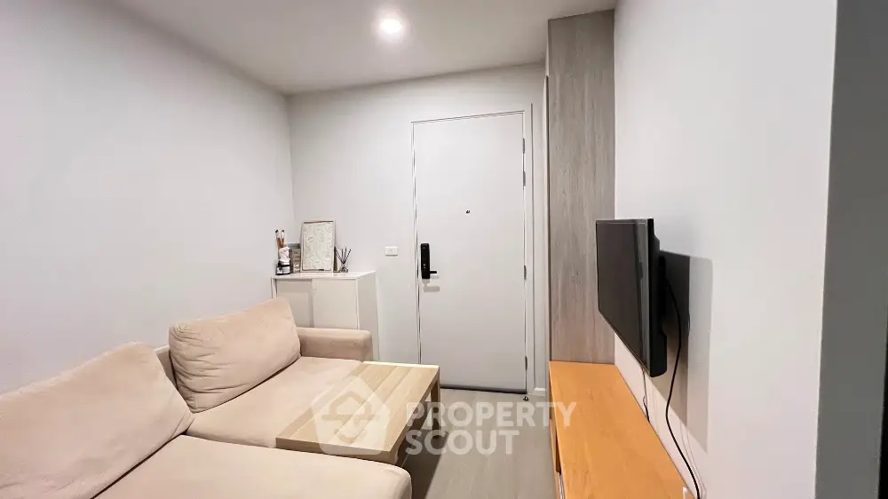 Cozy modern living room with beige sofa and wall-mounted TV