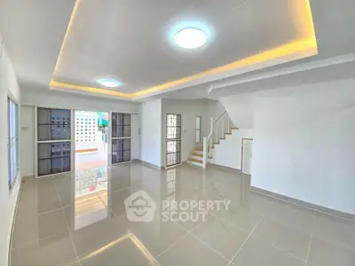 Spacious modern living room with glossy tiled floors and elegant ceiling lights