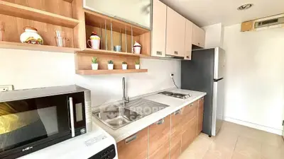 Modern kitchen with sleek cabinetry, built-in appliances, and stylish open shelving.