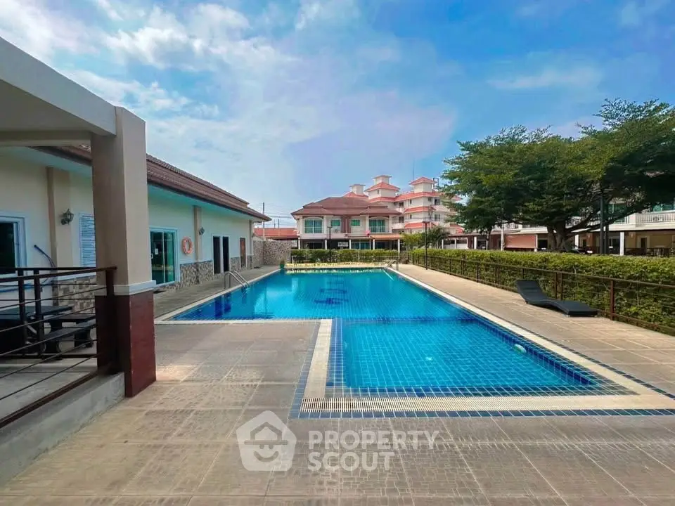 Luxurious residential complex with pristine swimming pool and modern architecture.