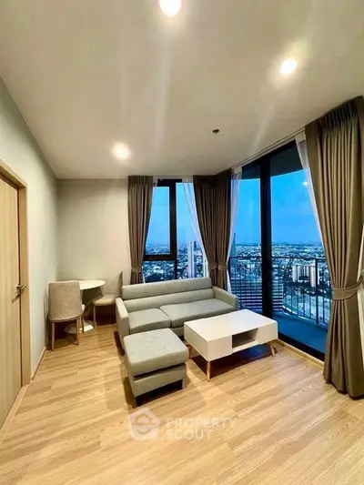 Modern living room with city view and stylish furniture in high-rise apartment.