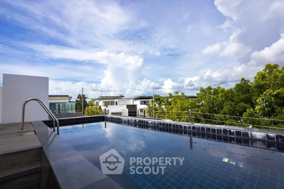 Luxurious rooftop pool with stunning sky view in modern residential area.
