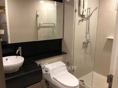 Modern bathroom with sleek fixtures and glass shower enclosure
