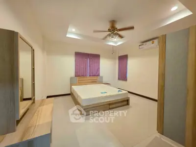 Spacious bedroom with modern ceiling fan and air conditioning