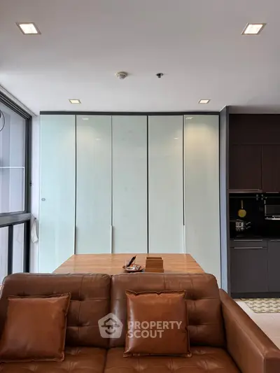 Modern living room with sleek design and brown leather sofa