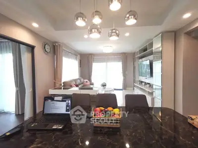 Spacious modern living room with elegant lighting and open layout, perfect for family gatherings.