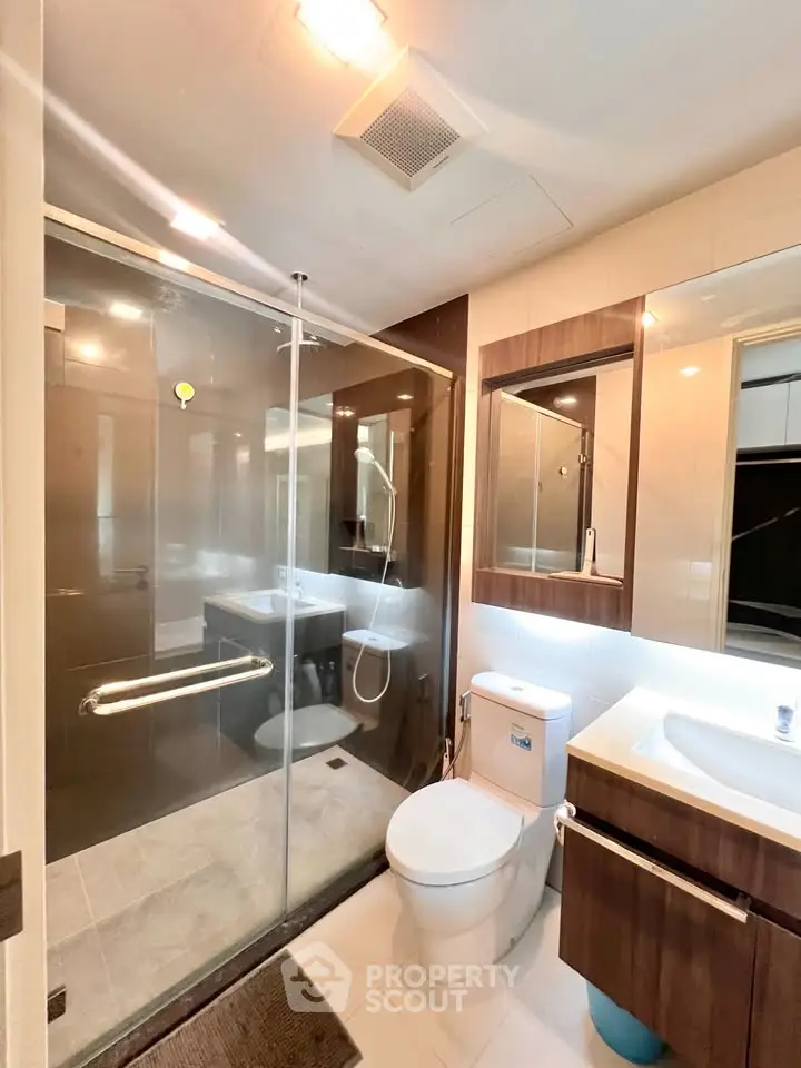 Modern bathroom with glass shower and sleek fixtures