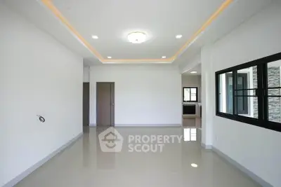 Spacious modern living room with sleek tile flooring and recessed lighting