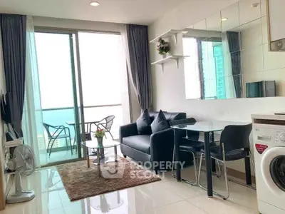 Modern living room with ocean view, balcony, and stylish furnishings.
