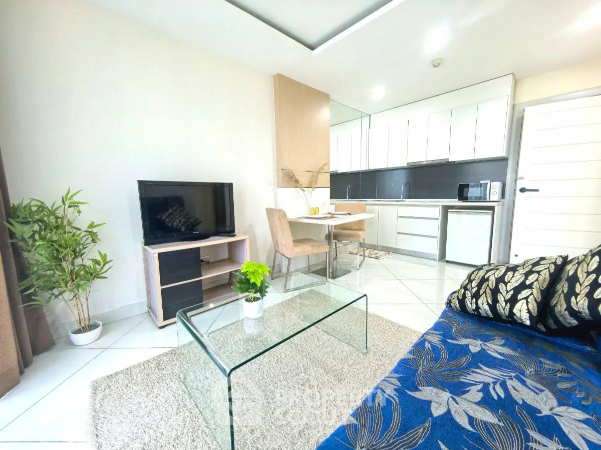Modern open-plan living room with sleek kitchen and stylish decor