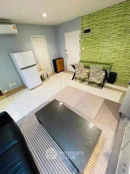 Modern living room with stylish decor and open layout, featuring a sleek coffee table and dining area.