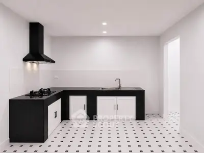 Modern kitchen with sleek black countertops and gas stove in minimalist design.