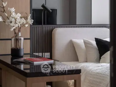 Modern bedroom with elegant decor and cozy ambiance, featuring a stylish desk and plush bedding.