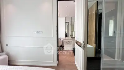 Modern bedroom with ensuite bathroom featuring elegant design and neutral tones.