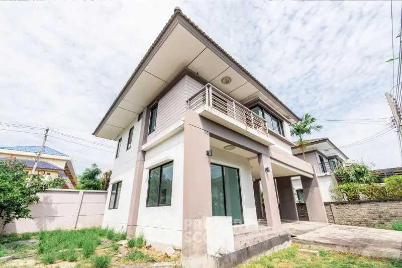 Modern two-story house with spacious balcony and garden view