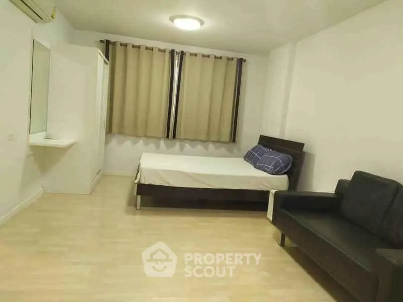 Spacious bedroom with modern furnishings and ample natural light.