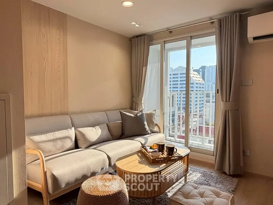 Chic living room with cozy sofa and city view balcony in modern apartment