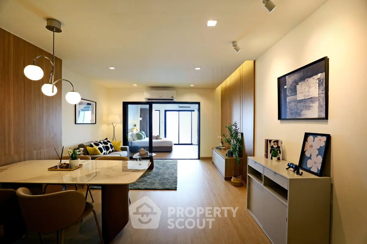 Modern living room with stylish decor and open layout, featuring elegant lighting and contemporary furniture.
