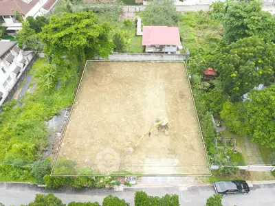 Prime land plot with lush surroundings, ideal for development, featuring clear boundaries and easy road access.