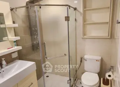 Modern bathroom with glass shower enclosure and sleek fixtures