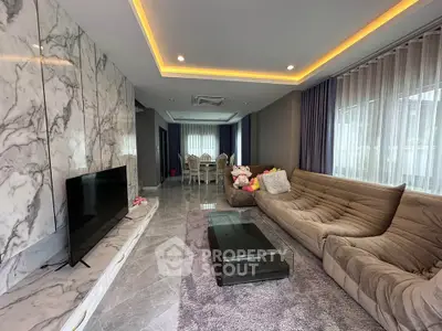 Luxurious living room with marble accents and modern furniture in a stylish home.
