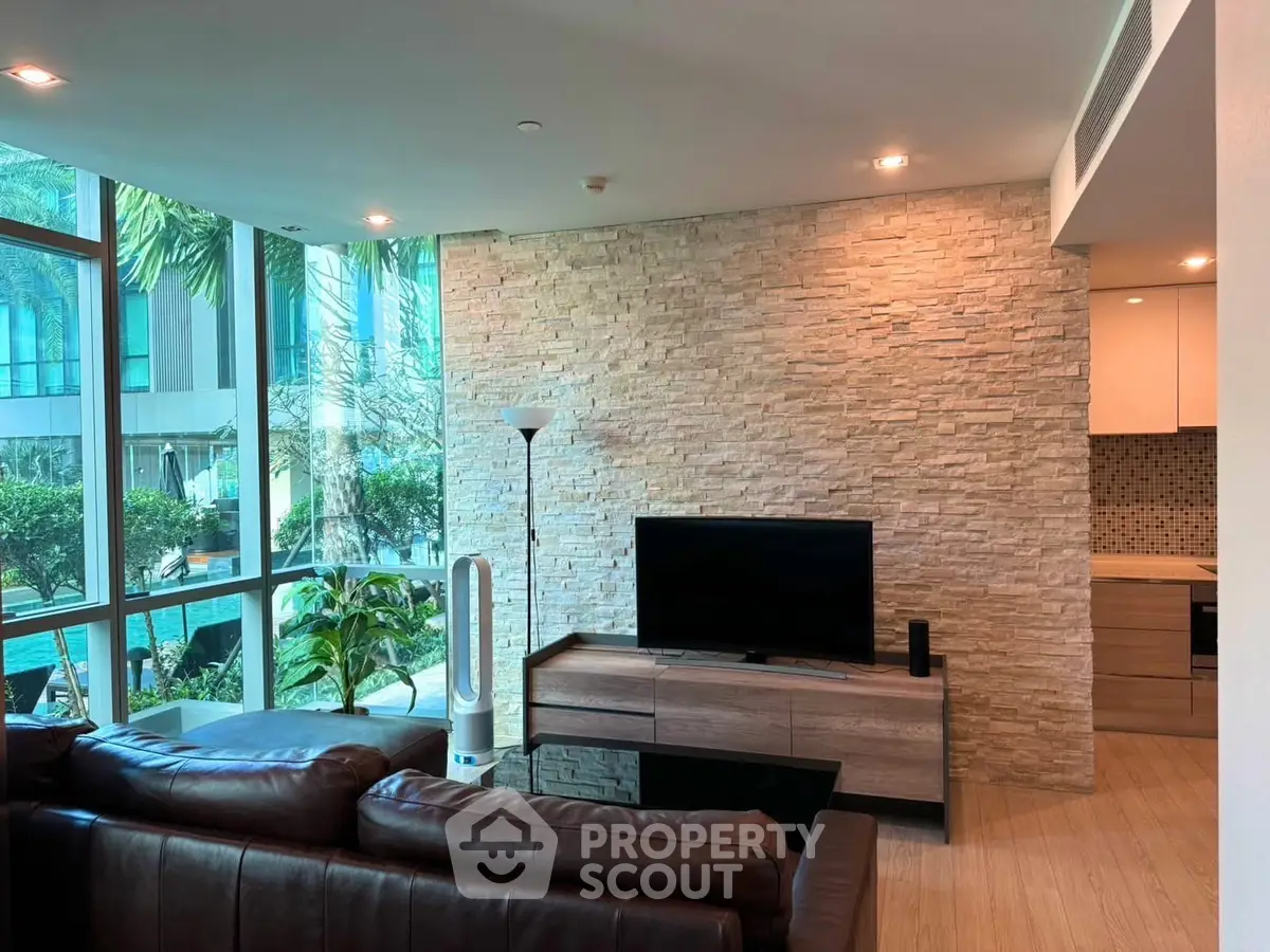 Luxurious living room with floor-to-ceiling windows and modern decor in a high-end apartment.