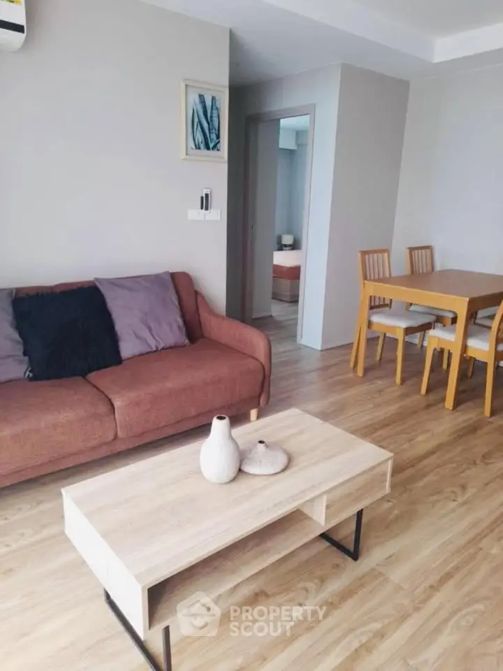 Modern living room with stylish furniture and wooden flooring in a cozy apartment.