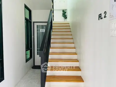 Modern staircase with sleek design and natural light in a contemporary home.
