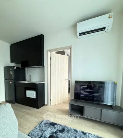 Modern compact living room with sleek kitchen and air conditioning