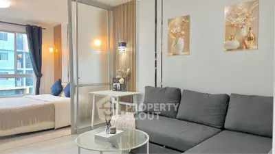 Modern studio apartment with stylish decor and cozy living area, featuring a comfortable sofa and elegant bedroom.