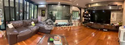 Spacious living room with modern decor and home gym equipment