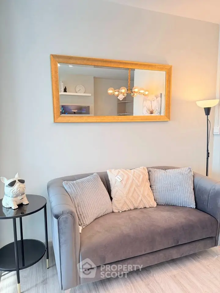 Stylish living room with elegant sofa and decorative mirror, perfect for modern home ambiance.