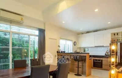 Modern open-layout kitchen and dining area with stylish decor and natural light.