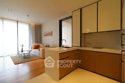 Modern open-layout living room with sleek kitchen and natural light