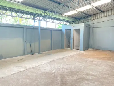 Spacious industrial-style storage unit with metal roof and concrete floor
