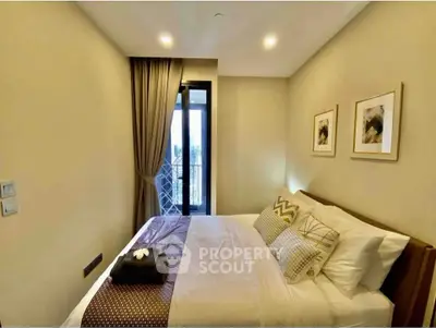 Cozy bedroom with elegant decor and balcony access in modern apartment