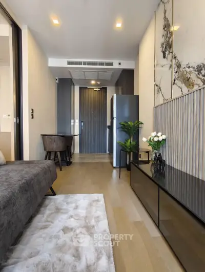 Modern living room with stylish decor and open layout, featuring a cozy sofa and elegant furnishings.