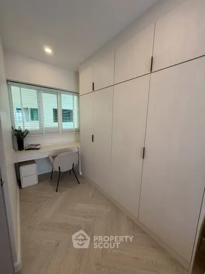 Modern study room with built-in storage and sleek desk, perfect for productivity and organization.