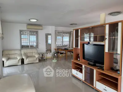 Spacious living room with modern furniture and large windows for natural light