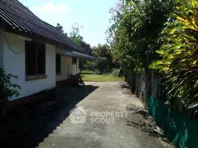 Charming rural property with spacious outdoor area and lush greenery, perfect for tranquil living.
