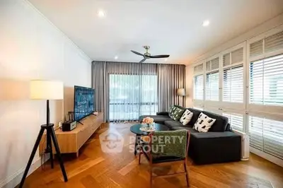 Spacious living room with modern decor and large windows for natural light.