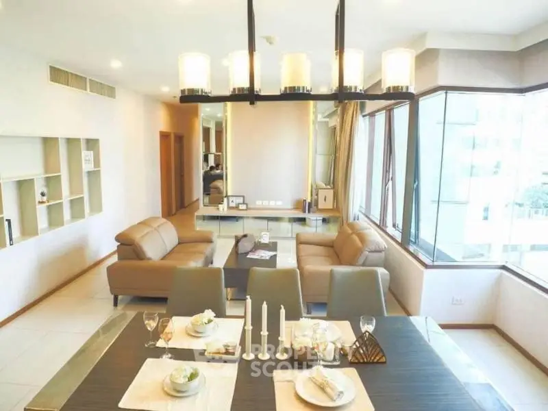 Spacious modern living room with elegant dining area and large windows offering natural light.