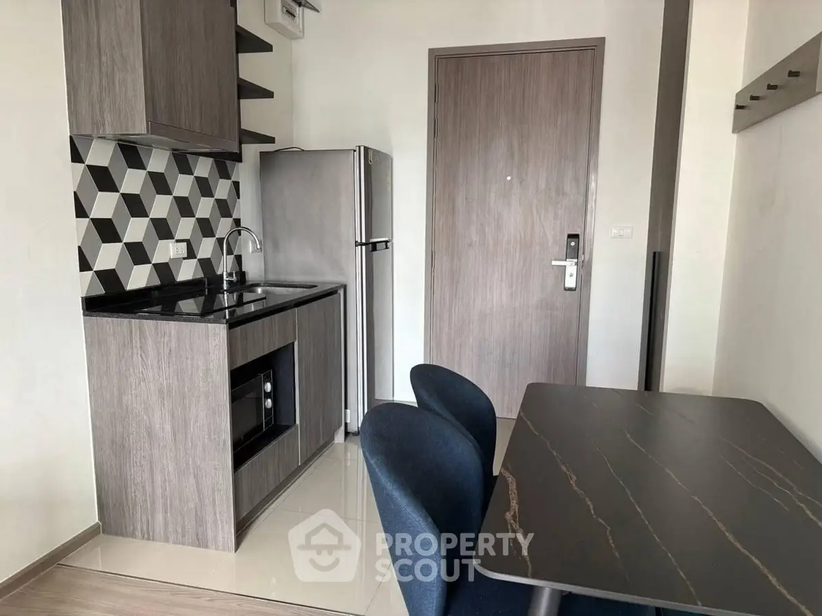 Modern compact kitchen with sleek design and dining area