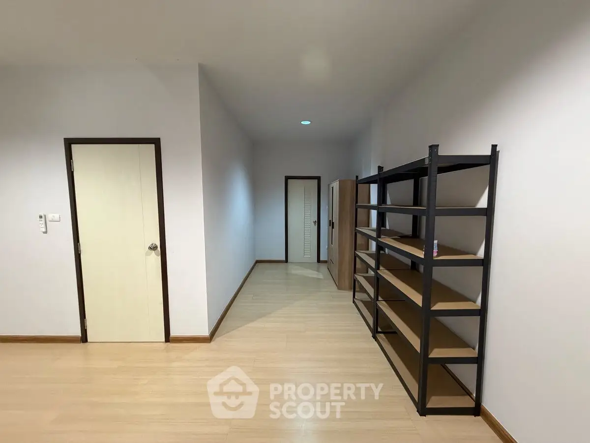 Spacious storage room with metal shelving and wooden flooring
