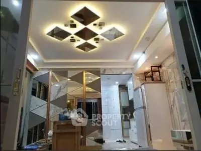 Luxurious modern kitchen with mirrored ceiling and sleek appliances