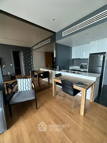 Modern open-layout kitchen with sleek design and wooden flooring