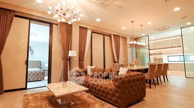Luxurious open-plan living room with elegant decor and modern lighting