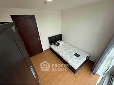 Cozy single bedroom with wooden flooring and modern furnishings