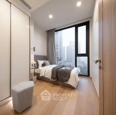 Modern bedroom with city view, featuring sleek design and cozy ambiance.